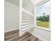 The bedroom features wood-look floors and a window with new blinds at 15296 Sw 56Th Terrace Rd, Ocala, FL 34473
