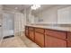 Bright bathroom with a double vanity, granite countertop, and shower-tub combo at 16137 Azure Key St, Winter Garden, FL 34787