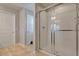 Bathroom with glass shower, neutral tile, and white cabinets at 16137 Azure Key St, Winter Garden, FL 34787