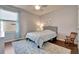 Cozy bedroom featuring hardwood floors, a queen bed, a ceiling fan and a large window at 16137 Azure Key St, Winter Garden, FL 34787