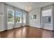 Bright room featuring hardwood floors, large windows with patterned curtains and a modern light fixture at 16137 Azure Key St, Winter Garden, FL 34787