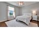 Cozy bedroom with a white bed, pink ceiling fan, and ample natural light at 16137 Azure Key St, Winter Garden, FL 34787