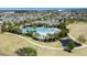 Aerial view showcases a large resort-style pool with ample seating and lush landscaping at 16137 Azure Key St, Winter Garden, FL 34787