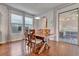 Dining room with hardwood floors, a wooden dining table, and sliding glass doors to the patio at 16137 Azure Key St, Winter Garden, FL 34787