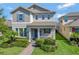 Charming two-story home featuring manicured landscaping and a welcoming front porch at 16137 Azure Key St, Winter Garden, FL 34787