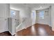 Upstairs hallway with wood floors, white banister, and natural light from the windows at 16137 Azure Key St, Winter Garden, FL 34787