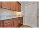 Butler's pantry features granite countertops, wooden cabinets, and tiled backsplash at 16137 Azure Key St, Winter Garden, FL 34787