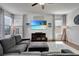 Bright living room featuring a shiplap accent wall, recessed lighting, and large windows with patterned curtains at 16137 Azure Key St, Winter Garden, FL 34787