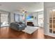 Cozy living room with hardwood floors, a large sectional sofa, and a sliding door to the patio at 16137 Azure Key St, Winter Garden, FL 34787
