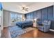 Stylish main bedroom with accent wall, ceiling fan, and lots of light from the windows at 16137 Azure Key St, Winter Garden, FL 34787