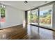 Bedroom featuring hardwood floors, white walls, and sliding glass doors to a balcony at 1634 Hull Cir, Orlando, FL 32806
