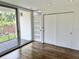 Bedroom with sliding doors to a patio and sliding closet doors, hardwood floors at 1634 Hull Cir, Orlando, FL 32806