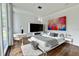 Bedroom featuring hardwood floors, a bed, modern art, and plenty of natural light at 1634 Hull Cir, Orlando, FL 32806