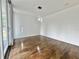 Empty room with hardwood floors, white walls, baseboards and natural lighting at 1634 Hull Cir, Orlando, FL 32806