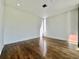 Empty room featuring hardwood floors, white walls and natural lighting at 1634 Hull Cir, Orlando, FL 32806