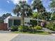 Modern home featuring clean lines, large windows, complemented by mature palm trees and lush landscaping at 1634 Hull Cir, Orlando, FL 32806