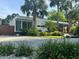 A modern home with lush landscaping, a well-manicured lawn, and gravel driveway for added curb appeal at 1634 Hull Cir, Orlando, FL 32806