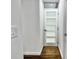 Hallway with hardwood floors, white walls, and a modern door with glass panels at 1634 Hull Cir, Orlando, FL 32806