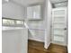 Hallway featuring hardwood floors, white walls and doors, and modern fixtures at 1634 Hull Cir, Orlando, FL 32806