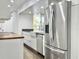 Stainless steel refrigerator in a bright kitchen with butcher block countertops at 1634 Hull Cir, Orlando, FL 32806