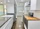 Modern kitchen with white cabinets, stainless steel appliances, and butcher block countertops at 1634 Hull Cir, Orlando, FL 32806