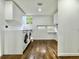 Well-lit laundry room with modern washer and dryer units and built-in storage at 1634 Hull Cir, Orlando, FL 32806