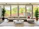 Stylish living room with a large sofa, area rug, and floor-to-ceiling windows at 1634 Hull Cir, Orlando, FL 32806