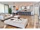 Spacious open-concept living area featuring hardwood floors, and seamless access to a modern kitchen and dining area at 1634 Hull Cir, Orlando, FL 32806