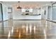 An open-concept design boasting sleek floors, an island, and a kitchen, creating a seamless flow at 1634 Hull Cir, Orlando, FL 32806