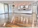 Spacious living area with smooth hardwood floors and seamless access to the open kitchen at 1634 Hull Cir, Orlando, FL 32806