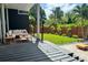 Inviting back patio with outdoor seating, a manicured lawn, and privacy fence, ideal for relaxing or entertaining at 1634 Hull Cir, Orlando, FL 32806