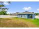 Bright back yard with lush green grass and a privacy fence, offering a serene outdoor space at 1730 Ribbon Falls Pkwy, Orlando, FL 32824
