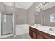 Well-lit bathroom features a double vanity, bathtub, shower and a large mirror at 1730 Ribbon Falls Pkwy, Orlando, FL 32824