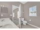 Bathroom features a double sink, tile floor, window and a toilet with a door leading to a bedroom at 1730 Ribbon Falls Pkwy, Orlando, FL 32824