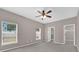 This bedroom features neutral paint, carpet floors, lots of natural light, and a ceiling fan, creating a comfortable retreat at 1730 Ribbon Falls Pkwy, Orlando, FL 32824