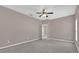 Spacious bedroom featuring neutral paint, carpet, and a ceiling fan with an open doorway at 1730 Ribbon Falls Pkwy, Orlando, FL 32824