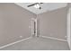 Carpeted bedroom featuring neutral paint, a ceiling fan and open doorway to walk-in closet at 1730 Ribbon Falls Pkwy, Orlando, FL 32824