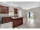 Well-equipped kitchen features dark wood cabinets, an island, stainless steel appliances, and a sliding door to the backyard at 1730 Ribbon Falls Pkwy, Orlando, FL 32824
