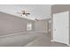 Bright living space featuring large windows, carpet, tile flooring, and a ceiling fan, creating a welcoming atmosphere at 1730 Ribbon Falls Pkwy, Orlando, FL 32824