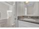 Bathroom vanity with stone countertops, sink, and view to the living space at 1851 Wimbledon St, Kissimmee, FL 34743