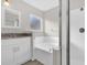 Bathroom featuring a separate shower and bathtub, complemented by a vanity at 1851 Wimbledon St, Kissimmee, FL 34743