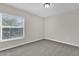 Cozy bedroom with neutral carpet flooring and natural lighting from window at 1851 Wimbledon St, Kissimmee, FL 34743