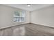 Bright bedroom with large windows offering a view of the outside greenery and community at 1851 Wimbledon St, Kissimmee, FL 34743