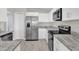 Stylish kitchen with white cabinetry, stainless steel appliances, and modern countertops at 1851 Wimbledon St, Kissimmee, FL 34743