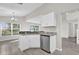 Modern kitchen featuring sleek white cabinets, stainless steel appliances, and granite countertops at 1851 Wimbledon St, Kissimmee, FL 34743