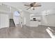 Open-concept living room featuring wood floors, a staircase, and an airy, open design at 1851 Wimbledon St, Kissimmee, FL 34743