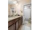Bathroom featuring granite counters, double sinks, and a walk-in shower at 193 Captiva Dr, Davenport, FL 33896