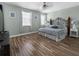 The bedroom features wood floors, a floral pattern bed, and a fan to keep you cool at 193 Captiva Dr, Davenport, FL 33896