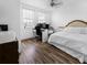 Bright bedroom featuring hardwood floors and a comfortable bed at 193 Captiva Dr, Davenport, FL 33896