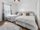 Bright bedroom featuring two beds, wood floors, and lots of natural light from the window at 193 Captiva Dr, Davenport, FL 33896
